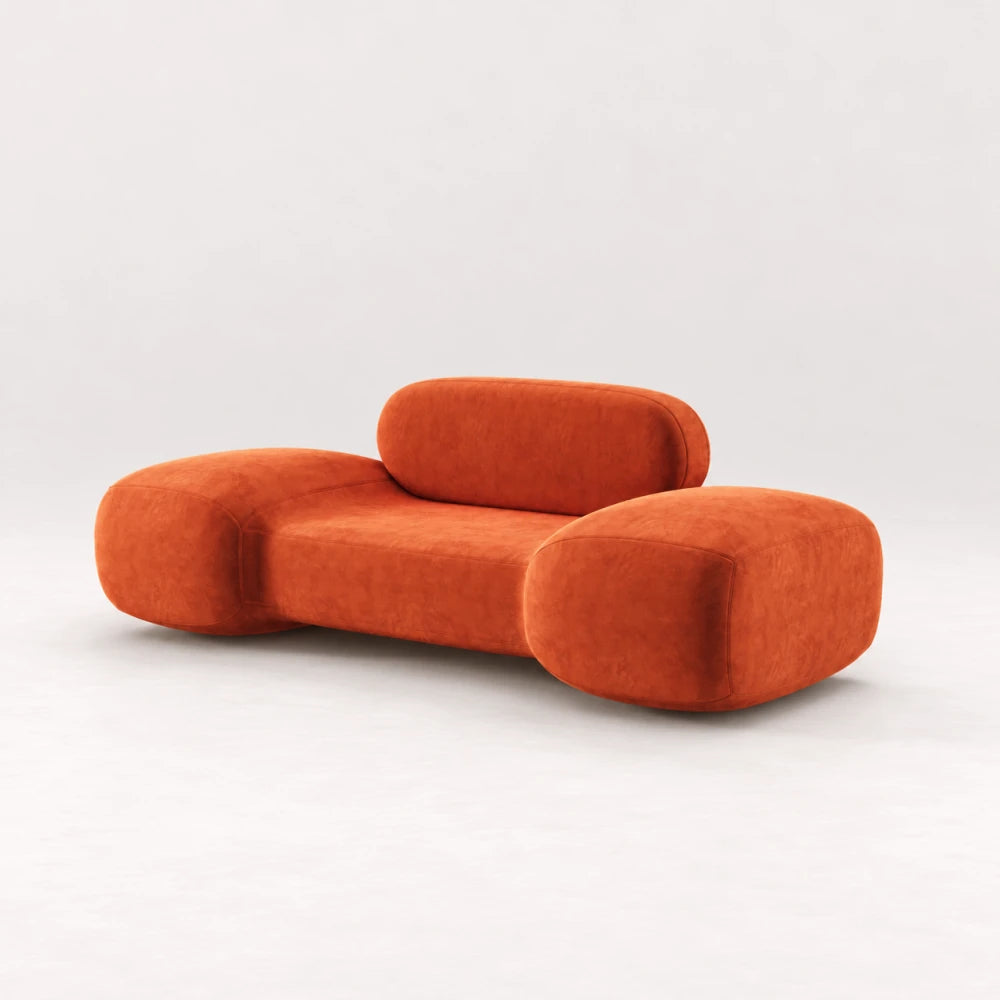 Front view of the Infinity Armchair 02 by Eva Szumilas in orange upholstery, with oversized rounded arms, a low seat and pill-shaped backrest.